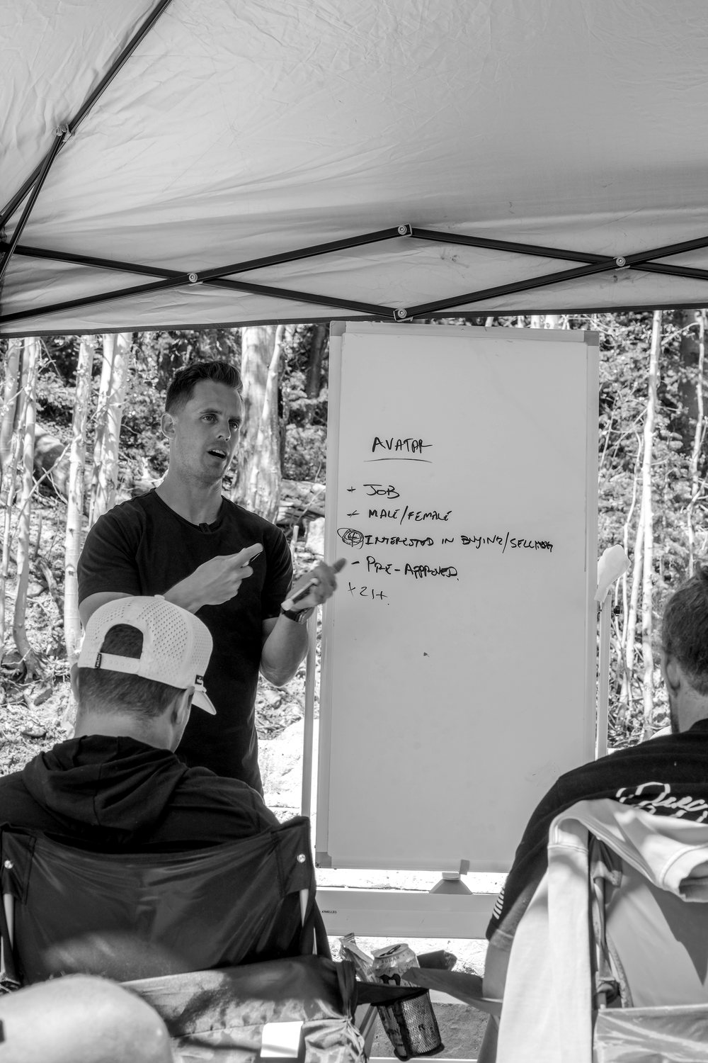 Brody at a whiteboard mapping a business with the group