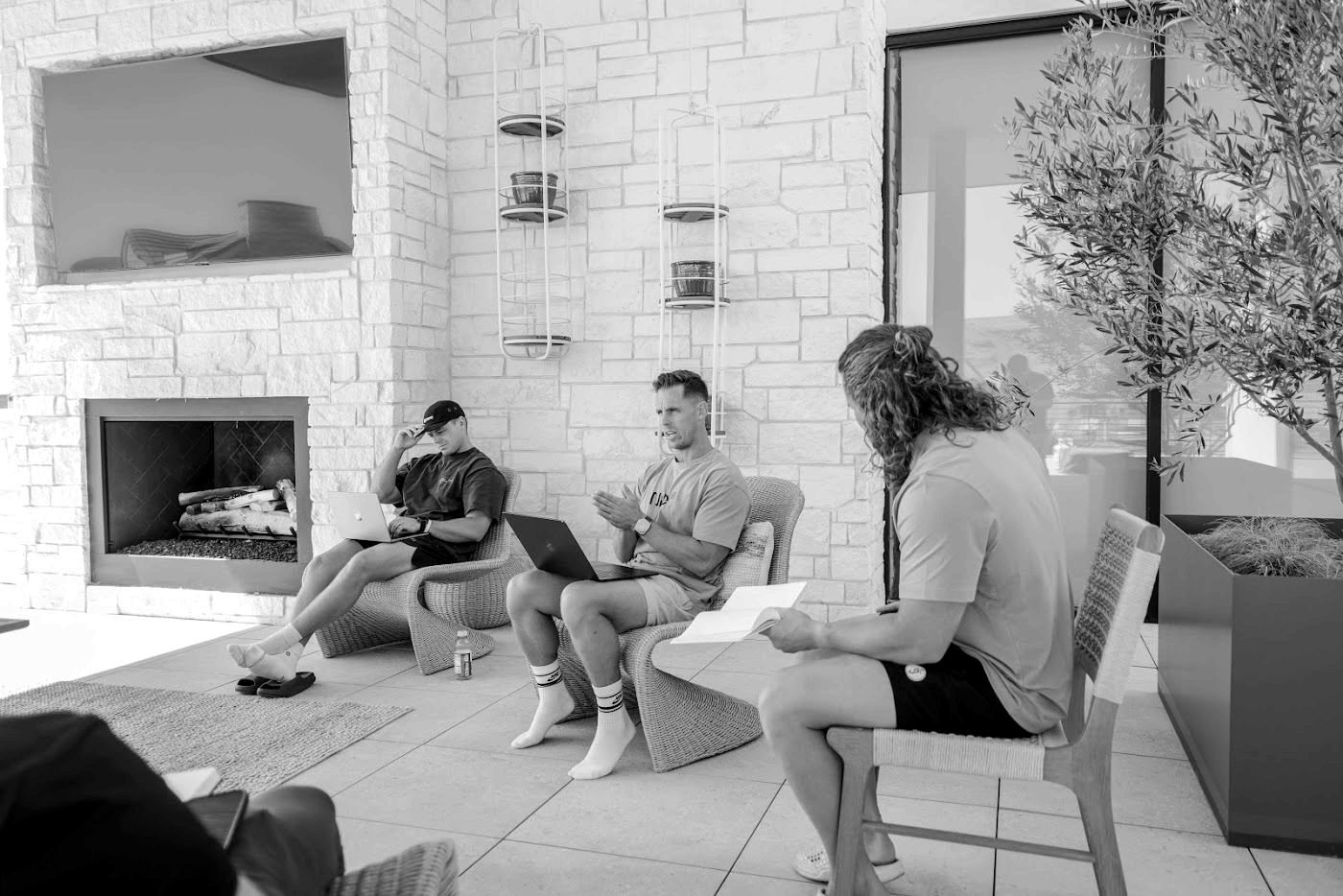 A small group working outside on a covered lanai